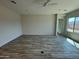 A bright, open living room featuring wood-look tile floors and modern neutral paint at 17308 W Royal Palm Rd, Waddell, AZ 85355