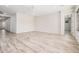 Bright and airy living room featuring wood-look tile flooring and recessed lighting at 17308 W Royal Palm Rd, Waddell, AZ 85355