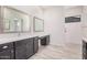 Double sinks and vanities highlight this main bath with access to a stand-up shower at 17308 W Royal Palm Rd, Waddell, AZ 85355