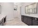 Double sinks and vanities highlight this main bath with access to a stand-up shower at 17308 W Royal Palm Rd, Waddell, AZ 85355