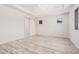 Main bedroom features a ceiling fan, wood-look tile floor and large windows at 17308 W Royal Palm Rd, Waddell, AZ 85355