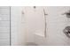 White tiled shower with bench and adjustable shower head at 17308 W Royal Palm Rd, Waddell, AZ 85355