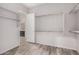 A walk-in closet with a door to the main bathroom features metal closet rods at 17308 W Royal Palm Rd, Waddell, AZ 85355