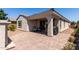 Paver-stone covered patio with dining table and chairs and stucco pillar at 19751 W Adams St, Buckeye, AZ 85326