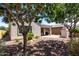 Backyard patio view featuring lush trees and greenery, plus a charming outdoor fireplace at 19751 W Adams St, Buckeye, AZ 85326