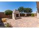 Beautiful backyard with custom stone fireplace, paved patio, and mature landscaping at 19751 W Adams St, Buckeye, AZ 85326
