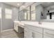 Well-lit bathroom featuring dual sinks, modern fixtures, and tiled flooring at 19751 W Adams St, Buckeye, AZ 85326