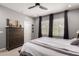 Comfortable bedroom with dresser, neutral colors, and large windows at 19751 W Adams St, Buckeye, AZ 85326