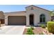Charming single-story home featuring a two-car garage and a well-manicured front yard at 19751 W Adams St, Buckeye, AZ 85326