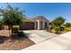 Lovely one-story home featuring a desert landscaped front yard and two-car garage at 19751 W Adams St, Buckeye, AZ 85326