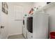 Laundry room featuring a washer, dryer, storage shelf and white cabinets creating a clean space at 19751 W Adams St, Buckeye, AZ 85326