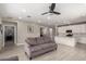 Open-concept living room with tile flooring, a ceiling fan, and views into the kitchen at 19751 W Adams St, Buckeye, AZ 85326