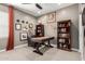 Well-lit office with desk, chair, bookshelves, artwork, and large window with natural light at 19751 W Adams St, Buckeye, AZ 85326