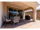 Covered patio featuring brick floors, seating area, grill and ample space for entertaining at 19751 W Adams St, Buckeye, AZ 85326