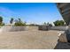 Fenced backyard with shed, gravel, and lush trees, ready for customization at 2036 W Windrose Dr, Phoenix, AZ 85029