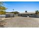 Expansive backyard features a storage shed, rock landscaping, and views of the surrounding desert at 2036 W Windrose Dr, Phoenix, AZ 85029