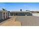 The backyard has a storage shed with decorative doors, rock landscaping, and a stone path at 2036 W Windrose Dr, Phoenix, AZ 85029