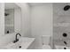 Modern bathroom features updated tiling, black fixtures, shower and tub combo, and a large mirror at 2036 W Windrose Dr, Phoenix, AZ 85029