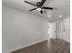 Neutral bedroom features wood look floors, fan, and a closet door at 2036 W Windrose Dr, Phoenix, AZ 85029