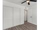 Bright bedroom features closet space, ceiling fan, and modern wood flooring at 2036 W Windrose Dr, Phoenix, AZ 85029