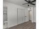 Bright bedroom features closet space, ceiling fan, and modern wood flooring at 2036 W Windrose Dr, Phoenix, AZ 85029
