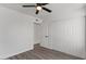 Bright bedroom features closet space, ceiling fan, and modern wood flooring at 2036 W Windrose Dr, Phoenix, AZ 85029