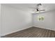 Neutral bedroom features wood look floors, fan, and a window providing natural light at 2036 W Windrose Dr, Phoenix, AZ 85029
