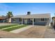 View of a single story home with manicured front yard, gravel landscaping and concrete driveway at 2036 W Windrose Dr, Phoenix, AZ 85029