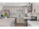Beautiful kitchen with stainless steel appliances, plenty of counter space, and modern white cabinets at 2036 W Windrose Dr, Phoenix, AZ 85029