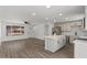 Open concept living and kitchen space features wood floors, island, ceiling fan, and large window at 2036 W Windrose Dr, Phoenix, AZ 85029
