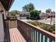 View from wood balcony overlooking neighborhood, lush greenery, and the property's private pool at 2050 W Nido Ave, Mesa, AZ 85202
