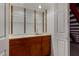 Basement kitchenette with wood cabinets, tile countertop, and glass shelves at 2050 W Nido Ave, Mesa, AZ 85202