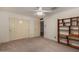 A carpeted bedroom features a double door closet, light fixture and a wooden bookcase at 2050 W Nido Ave, Mesa, AZ 85202