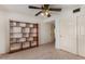 A simple bedroom features neutral carpet, a wooden bookcase, and white closet doors at 2050 W Nido Ave, Mesa, AZ 85202