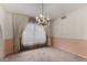 Empty dining room with chandelier and pale pink walls at 2050 W Nido Ave, Mesa, AZ 85202