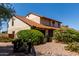 Charming two-story home with tile roof complemented by a stone walkway and mature landscaping at 2050 W Nido Ave, Mesa, AZ 85202