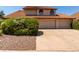 Charming two-story home with a tile roof, well-maintained landscaping, and a three car garage at 2050 W Nido Ave, Mesa, AZ 85202