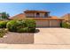Charming two-story home with a tile roof, well-maintained landscaping, and a three car garage at 2050 W Nido Ave, Mesa, AZ 85202
