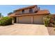Exterior of the house featuring a tile roof, spacious driveway, and manicured bushes at 2050 W Nido Ave, Mesa, AZ 85202