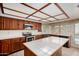 Bright eat-in kitchen with wood cabinetry, a center island and modern appliances at 2050 W Nido Ave, Mesa, AZ 85202