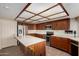 Traditional eat-in kitchen features wood cabinets, stainless appliances, and a tiled island at 2050 W Nido Ave, Mesa, AZ 85202