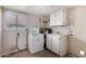 A small laundry room features a washing machine, sink, water heater and a door to the outside at 2050 W Nido Ave, Mesa, AZ 85202