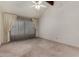This well-lit living room features a vaulted ceiling, neutral walls and carpeting, and large windows at 2050 W Nido Ave, Mesa, AZ 85202