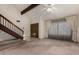 Spacious living room with a staircase, double doors, ceiling fan, and large windows providing natural light at 2050 W Nido Ave, Mesa, AZ 85202