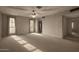 Spacious living room featuring large windows, neutral carpet, and great natural light at 2050 W Nido Ave, Mesa, AZ 85202