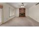 Cozy living area featuring a classic brick fireplace and bright windows with shutters at 2050 W Nido Ave, Mesa, AZ 85202