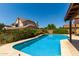 Inviting backyard with a sparkling blue pool and lush landscaping at 2050 W Nido Ave, Mesa, AZ 85202