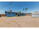 Backyard view of single story home with a gravel yard and tall palm trees at 2117 W 2Nd St, Mesa, AZ 85201