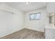 Bedroom with wood-look flooring, a window, and built-in shelving at 2117 W 2Nd St, Mesa, AZ 85201