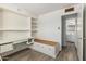 Bright bedroom featuring built-in desk and storage with adjacent bathroom access at 2117 W 2Nd St, Mesa, AZ 85201